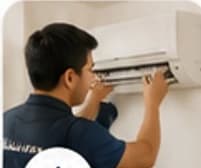 Technician servicing a wall-mounted air conditioner
